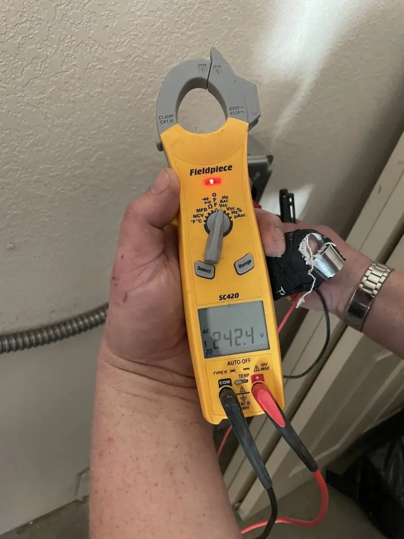 Voltage testing with clamp meter during Recessed Lighting Installation in Norcross